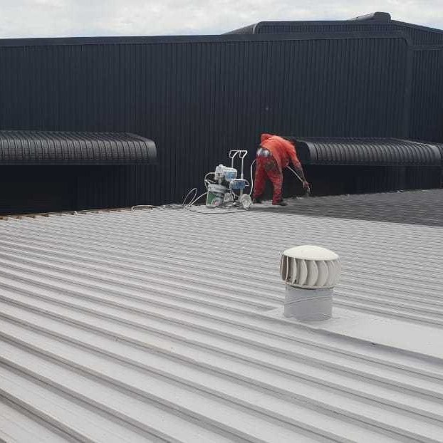 Commercial metal roof sprayed and waterproofed